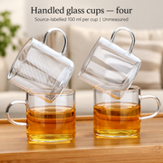 Handled glass cups — four