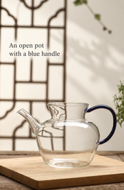 An open pot with a blue handle